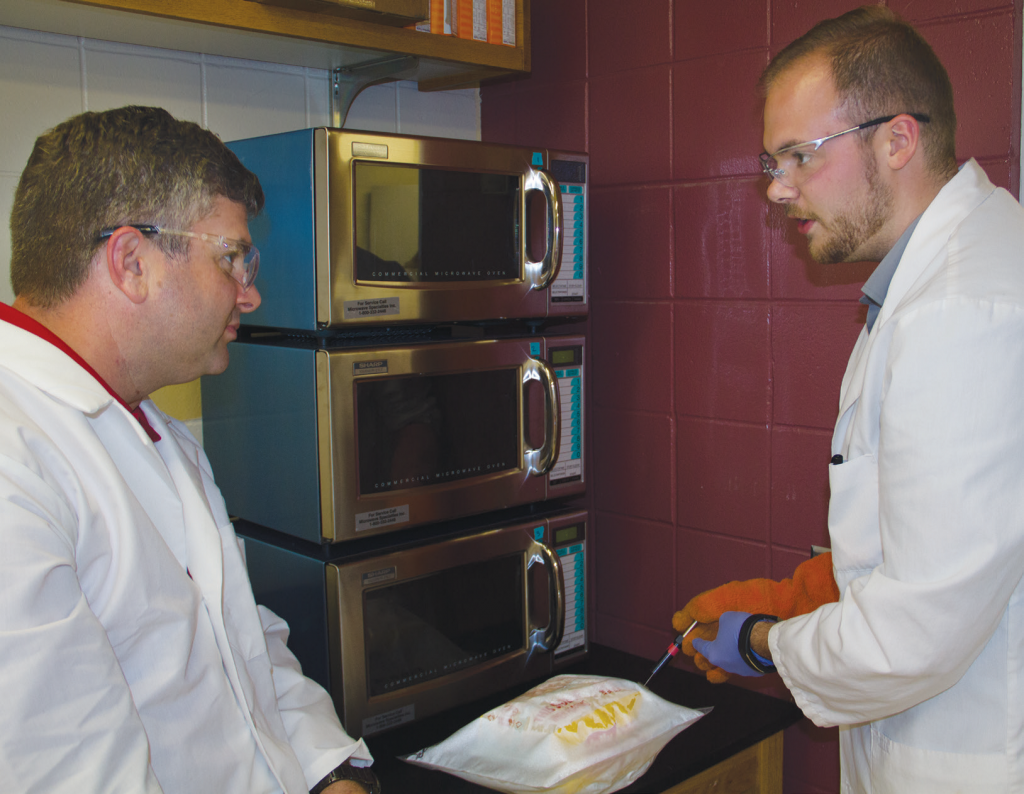 Keith Vorst and graduate student Nathan Davis evaluate the performance and safety of microwave popcorn