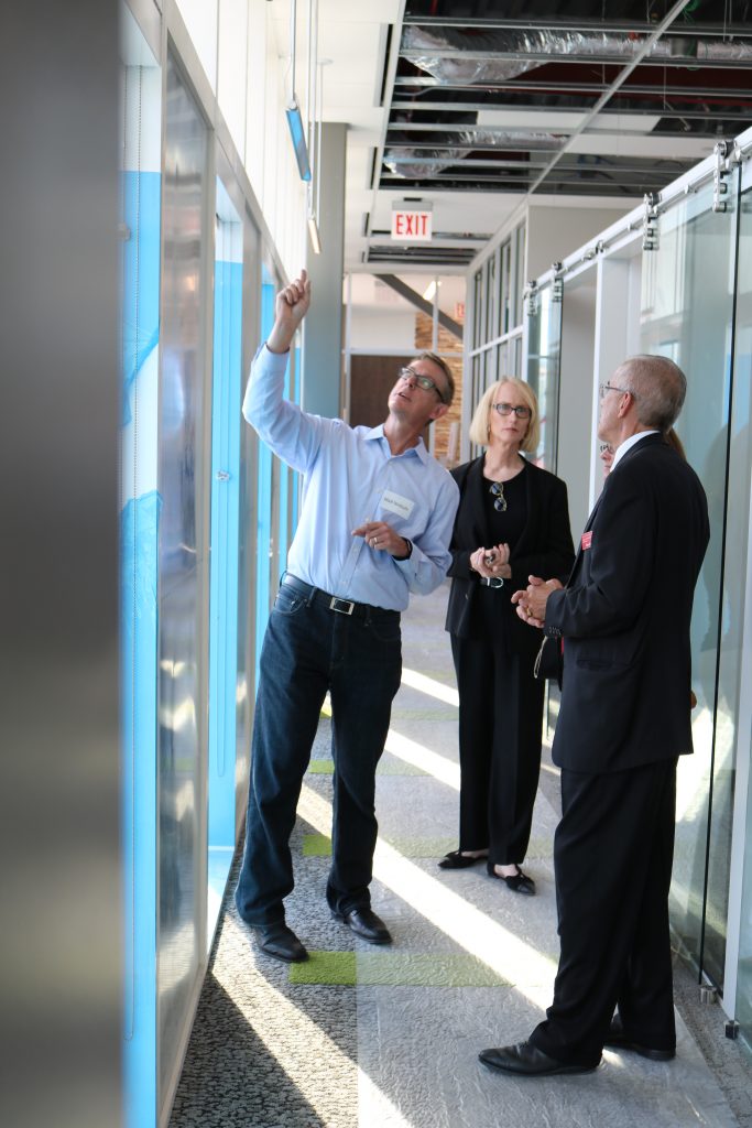 Examining in the windows in a hallway of CIRAS' new offices.