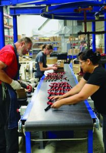 Double HH Manufacturing workers sort hitch pins.