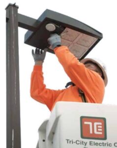 Tri-City Electric employee installs an LED light