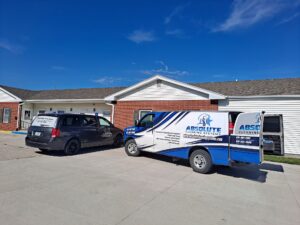 Absolute Cleaning Systems vans parked while employees are providing commercial cleaning services.