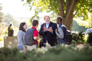 Iowa State director of graduate education for IMSE, standing outside with a group of students.