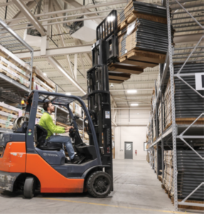 Man driving a fork truck in a facility